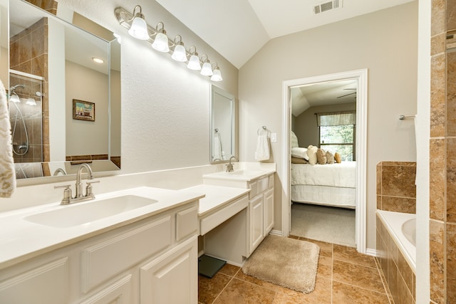 bathroom with vanity, separate shower and tub, and lofted ceiling