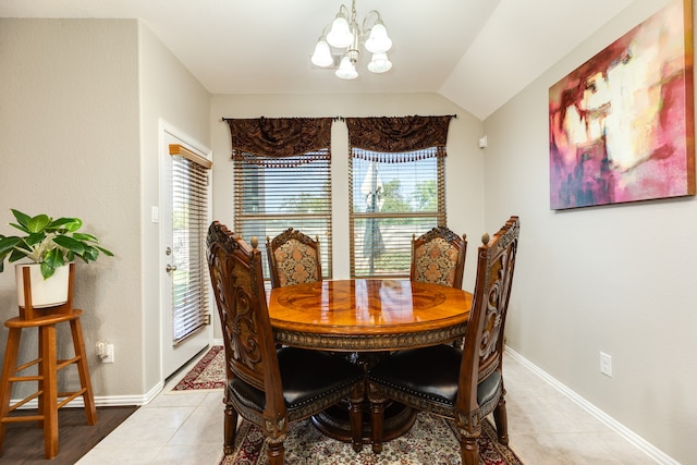 tiled dining area with lofted ceiling and a chandelier