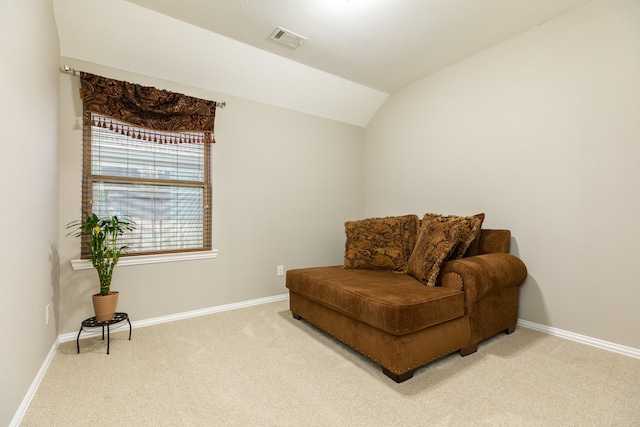 sitting room with carpet and vaulted ceiling