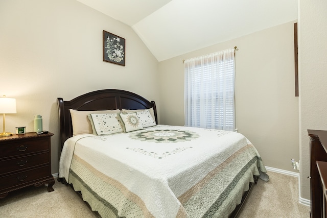 bedroom with light carpet and vaulted ceiling