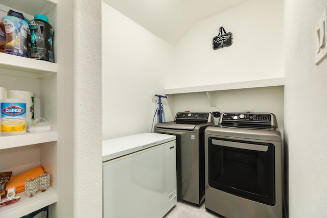 clothes washing area featuring separate washer and dryer