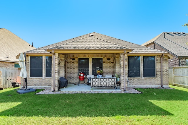 rear view of property with an outdoor living space, a yard, and a patio