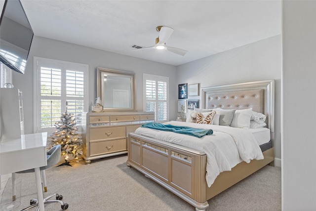 bedroom with light colored carpet and ceiling fan