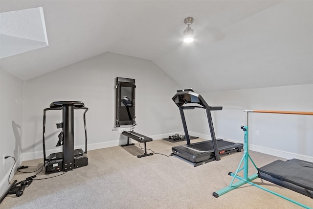 workout room featuring carpet floors and lofted ceiling