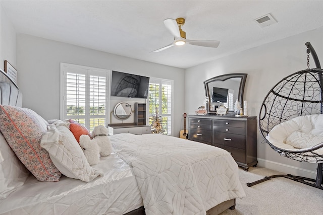 bedroom with ceiling fan and light carpet