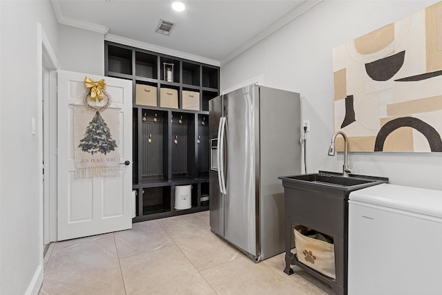 washroom featuring light tile patterned floors, ornamental molding, and sink