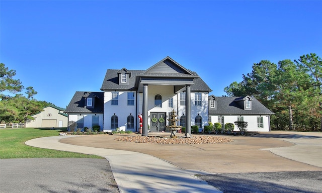 view of front facade with an outbuilding and a garage