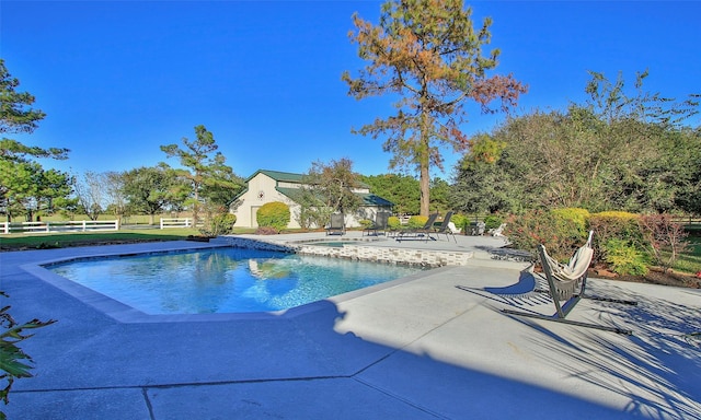 view of swimming pool featuring a patio area