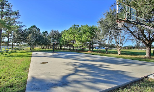 view of basketball court with a lawn