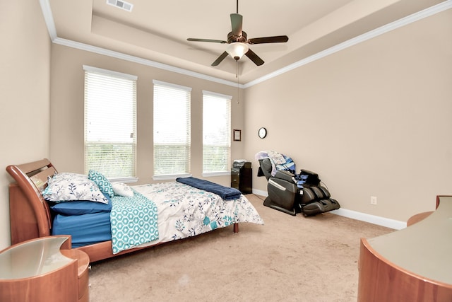 carpeted bedroom featuring a tray ceiling, ceiling fan, and ornamental molding