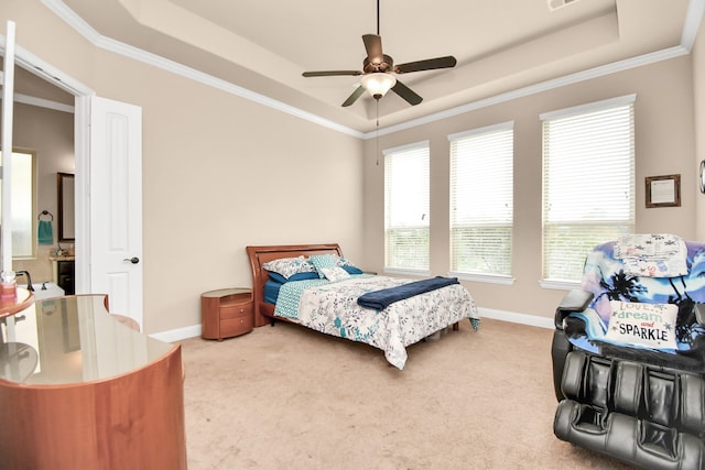 bedroom with a tray ceiling, ceiling fan, crown molding, and carpet