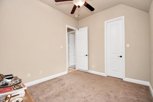 unfurnished bedroom with ceiling fan, light carpet, and vaulted ceiling