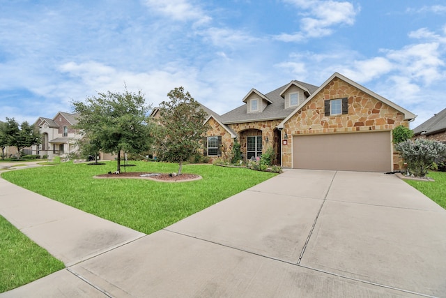 view of front of home with a garage and a front lawn