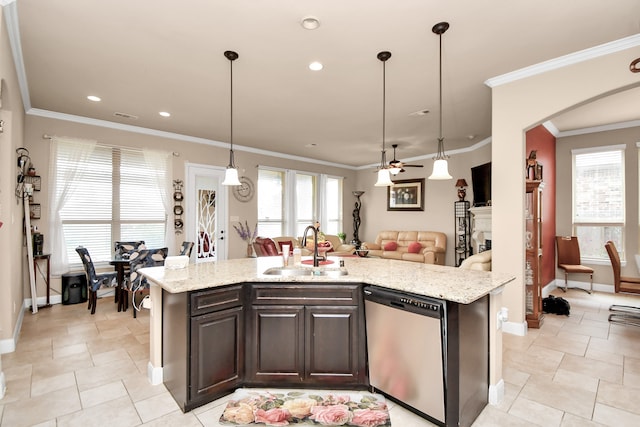 kitchen featuring dishwasher, decorative light fixtures, crown molding, and an island with sink