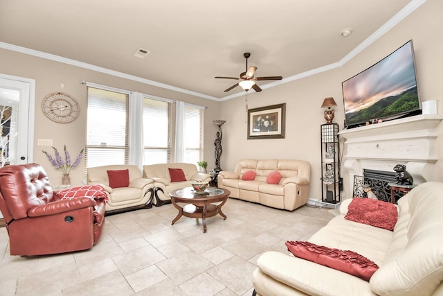 living room with ceiling fan, ornamental molding, and light tile patterned floors