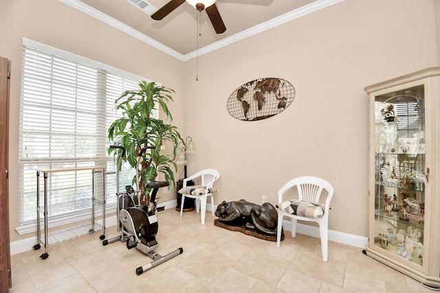 exercise area featuring ceiling fan, light tile patterned floors, a healthy amount of sunlight, and ornamental molding