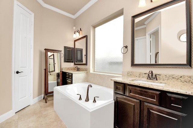 bathroom featuring a bathing tub, vanity, ornamental molding, and tile patterned flooring