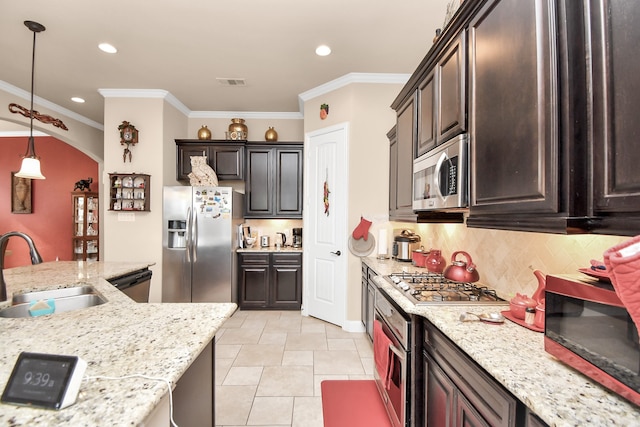 kitchen featuring sink, tasteful backsplash, crown molding, decorative light fixtures, and appliances with stainless steel finishes