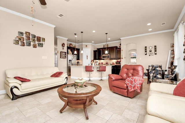 living room with light tile patterned floors, ceiling fan, and crown molding