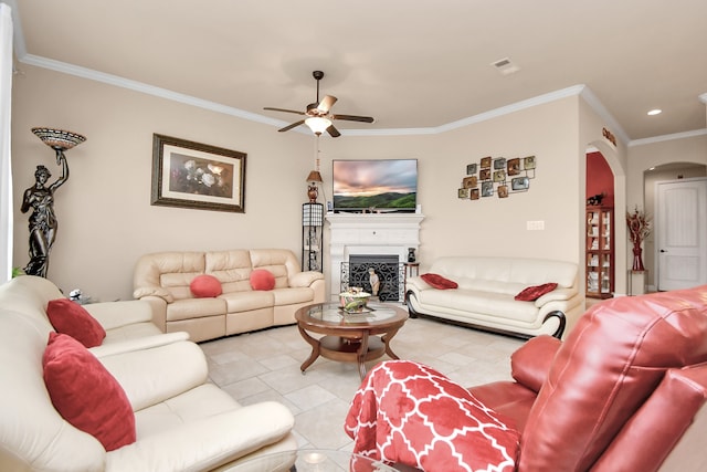 tiled living room featuring ceiling fan and crown molding