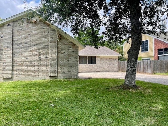 view of side of home featuring a lawn