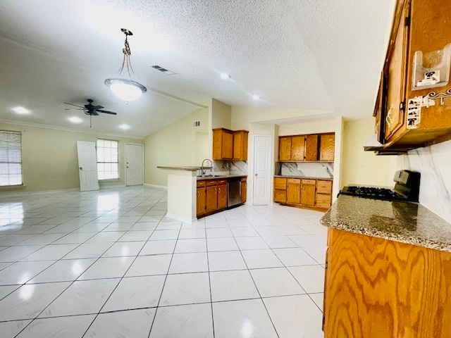 kitchen with stove, stainless steel dishwasher, ceiling fan, a textured ceiling, and light stone counters