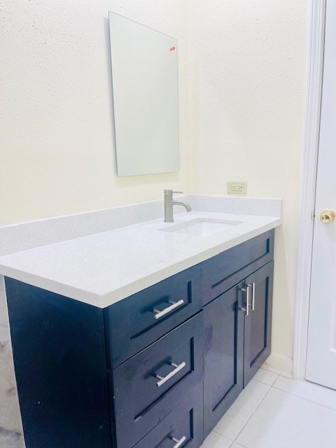 bathroom with tile patterned flooring and vanity