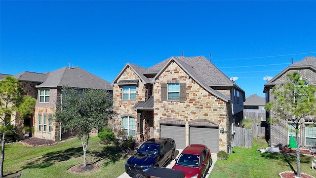 view of front of property featuring a garage and a front lawn