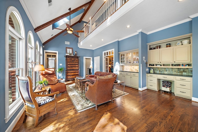 living room featuring ceiling fan, dark hardwood / wood-style flooring, high vaulted ceiling, and crown molding