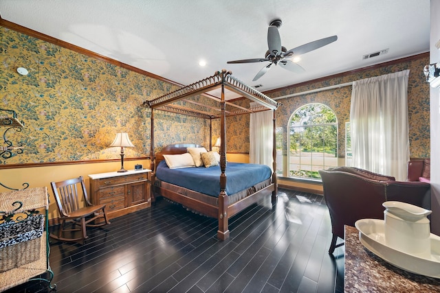 bedroom featuring ceiling fan, dark hardwood / wood-style flooring, and ornamental molding