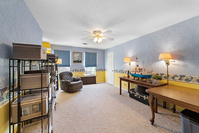 interior space featuring carpet flooring, ceiling fan, and a textured ceiling