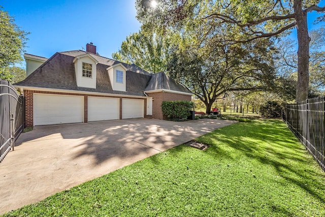 view of front of property with a garage and a front lawn