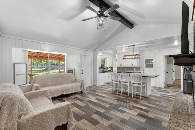 living room with ceiling fan, high vaulted ceiling, and beam ceiling