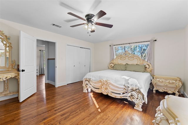 bedroom with ceiling fan, dark hardwood / wood-style flooring, and a closet