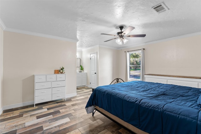 bedroom featuring crown molding, light hardwood / wood-style flooring, and a textured ceiling