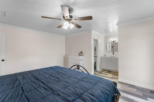 bedroom with crown molding, sink, a textured ceiling, and light wood-type flooring