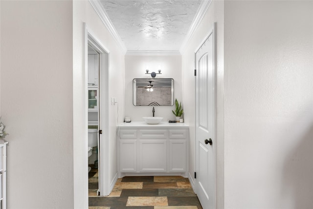 bathroom featuring hardwood / wood-style flooring, vanity, ornamental molding, a textured ceiling, and toilet