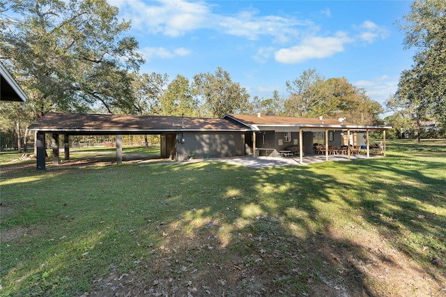 back of house featuring a yard and a patio