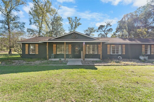 ranch-style home with a front yard and covered porch