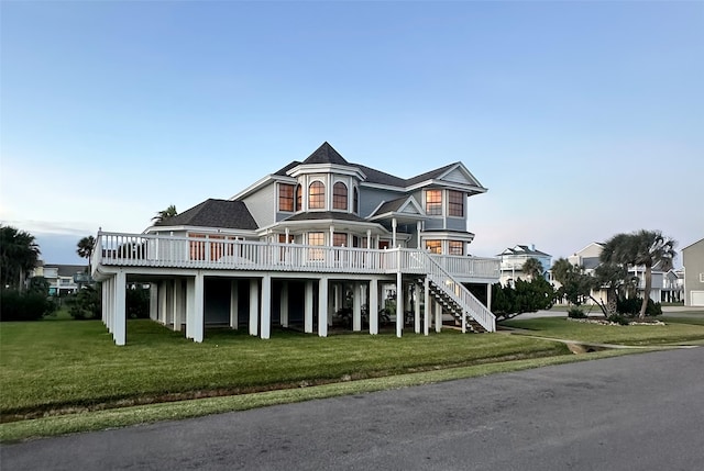 view of front facade featuring a deck and a front yard