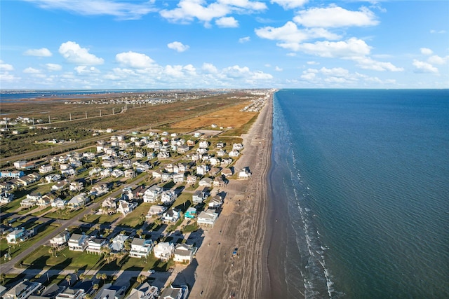 drone / aerial view with a residential view, a water view, and a beach view