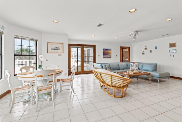 living area with light tile patterned floors, french doors, visible vents, and a healthy amount of sunlight