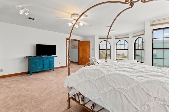 bedroom featuring baseboards, visible vents, and light colored carpet