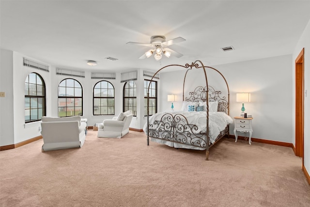 bedroom featuring light colored carpet, visible vents, and baseboards