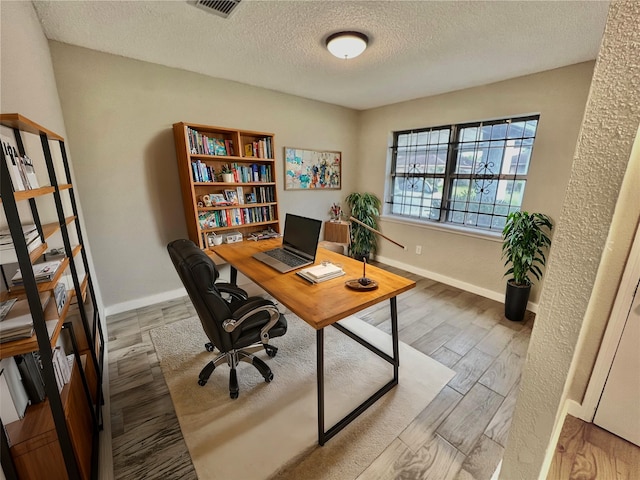 office area featuring hardwood / wood-style floors and a textured ceiling