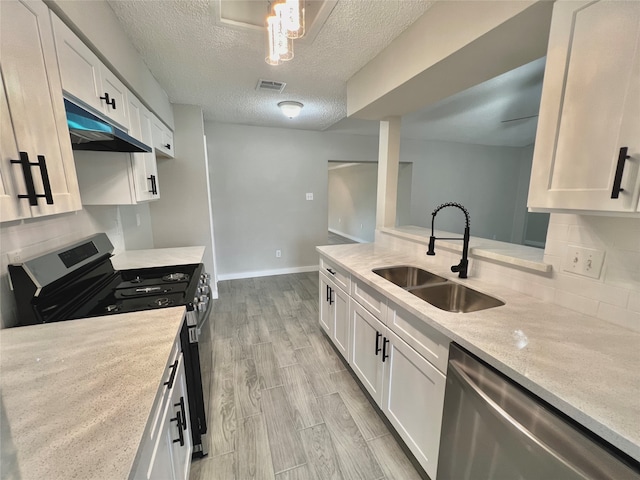 kitchen featuring range, sink, stainless steel dishwasher, light hardwood / wood-style floors, and white cabinetry