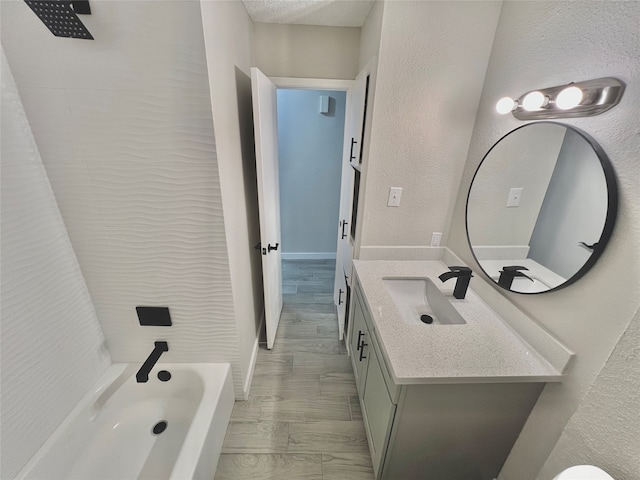 bathroom featuring shower / washtub combination, vanity, and hardwood / wood-style flooring