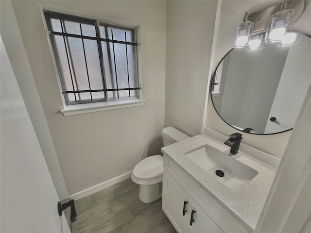 bathroom featuring vanity, toilet, and wood-type flooring