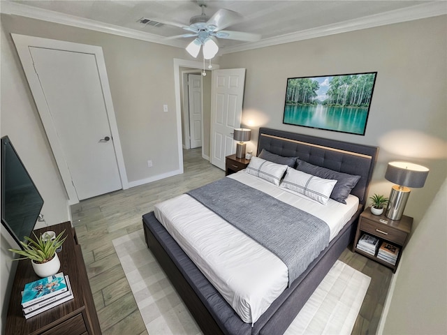 bedroom with ceiling fan, light wood-type flooring, and crown molding