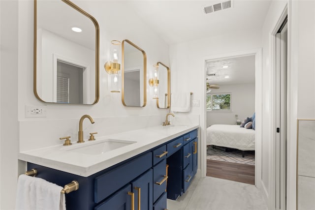 bathroom with hardwood / wood-style floors, vanity, and ceiling fan